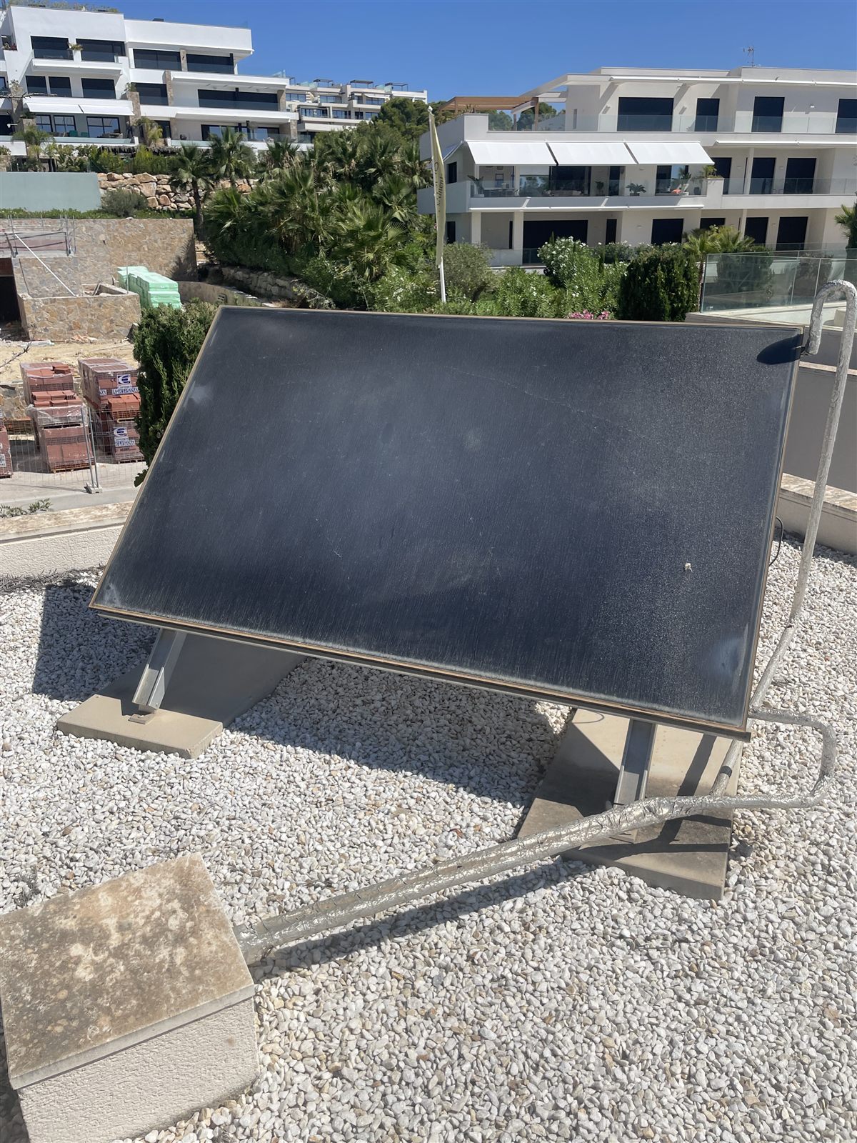 Solar panel on a tilted mount on a flat gravel roof in Torrevieja